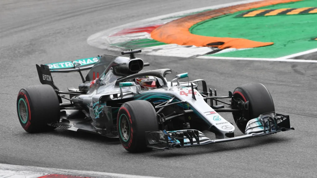 Lewis Hamilton lost his victory after being penalized for cutting a chicane while overtaking Kimi Raikkonen